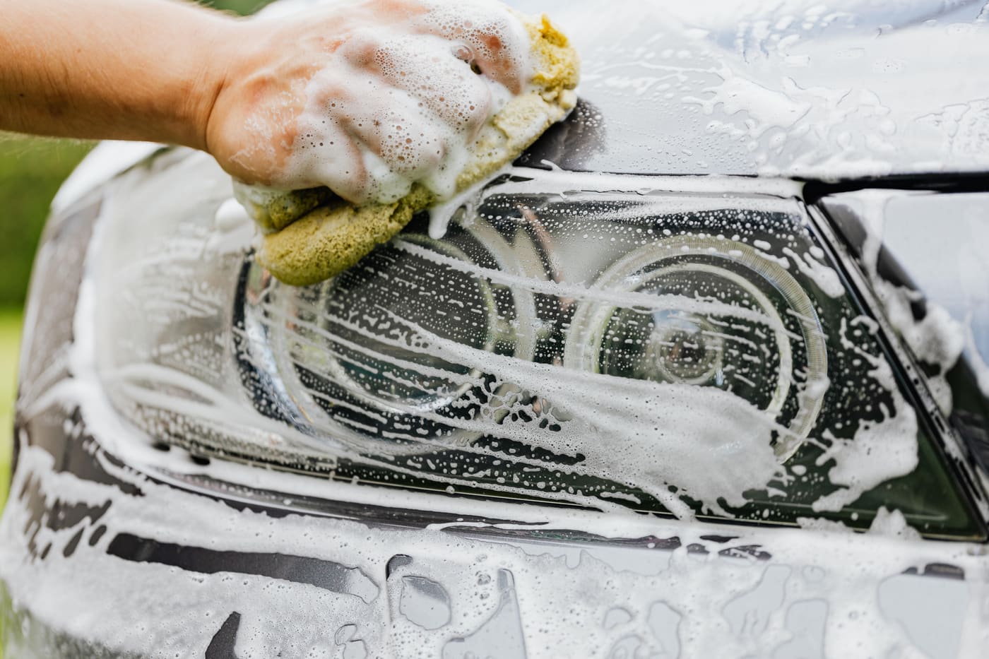 Hand detailing a car headlight